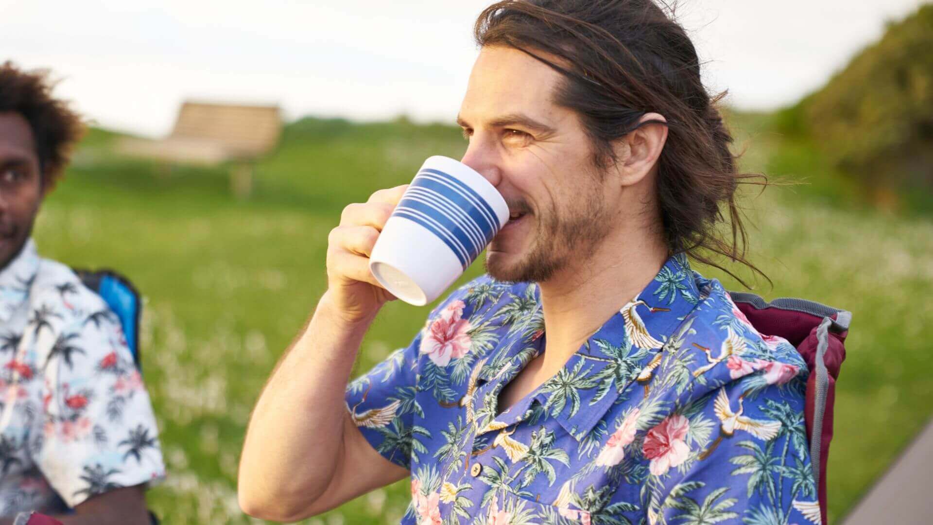 Man Drinking From A Camping Coffee Cup