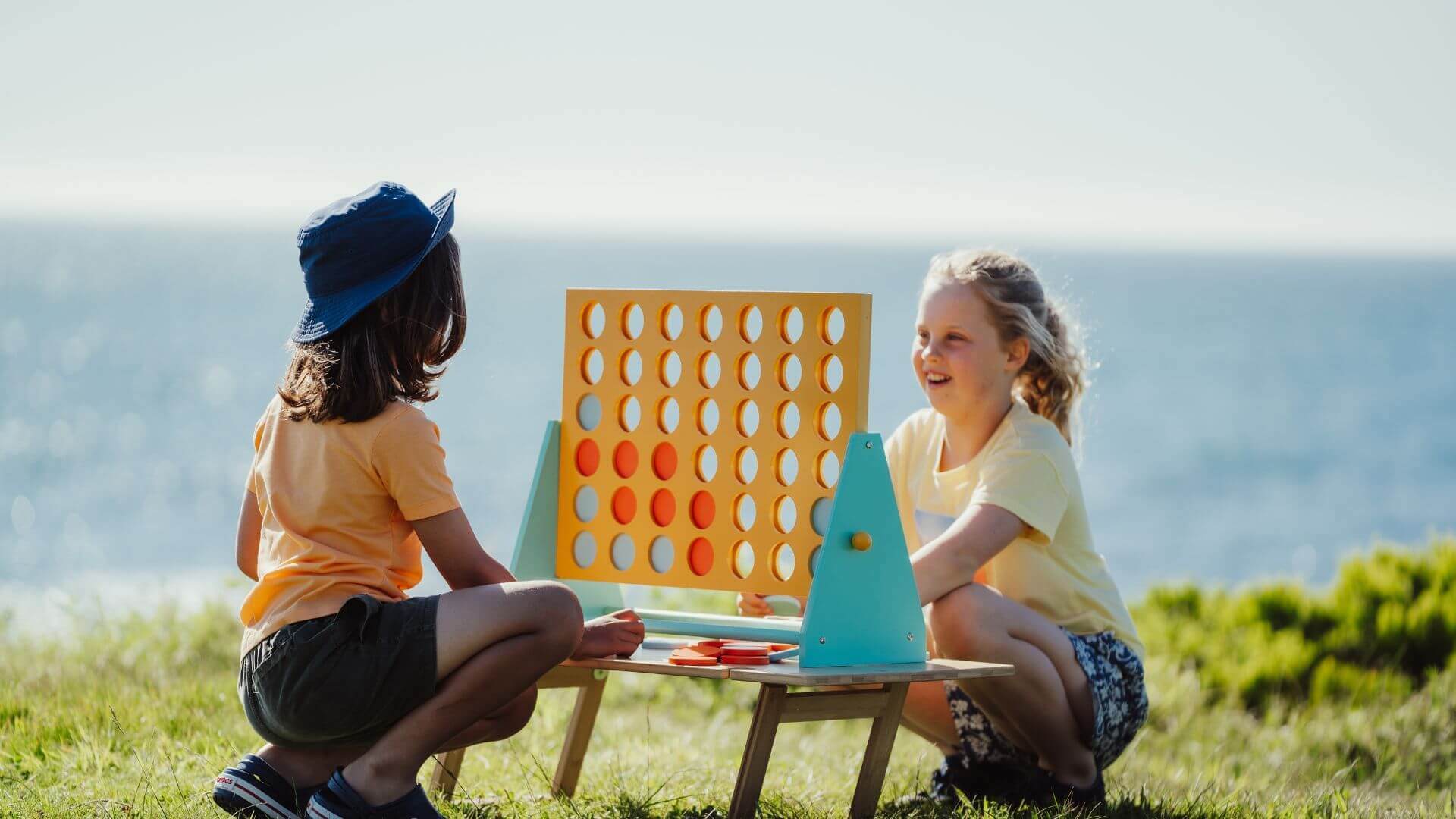 Kids Playing Games On A Small Camping Table