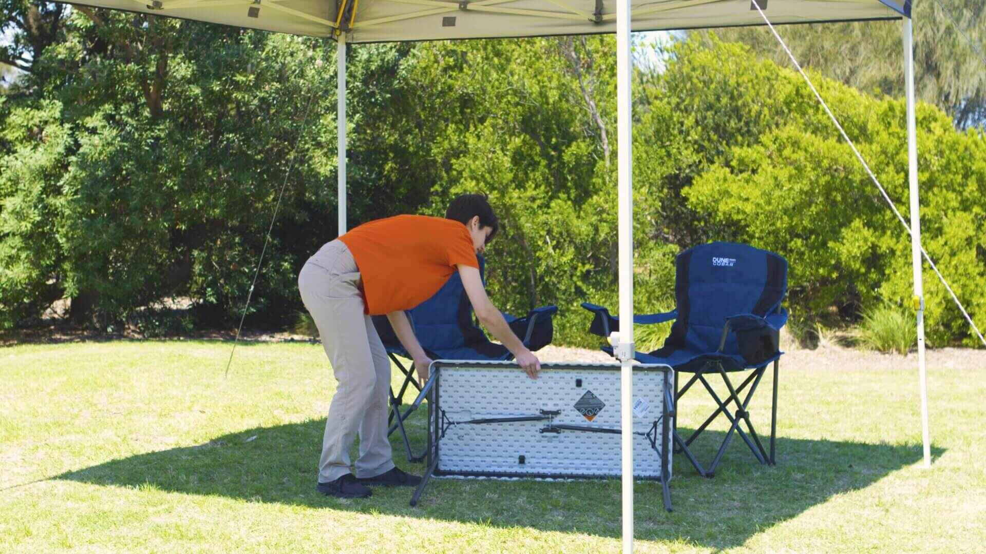 Setting Up A Camping Table Under A Gazebo