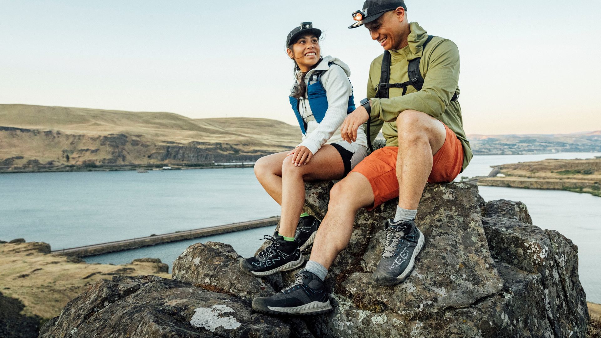 Two fitted hikers wearing Keen Men's Nxis Evo Waterproof Mid Hiking Shoes