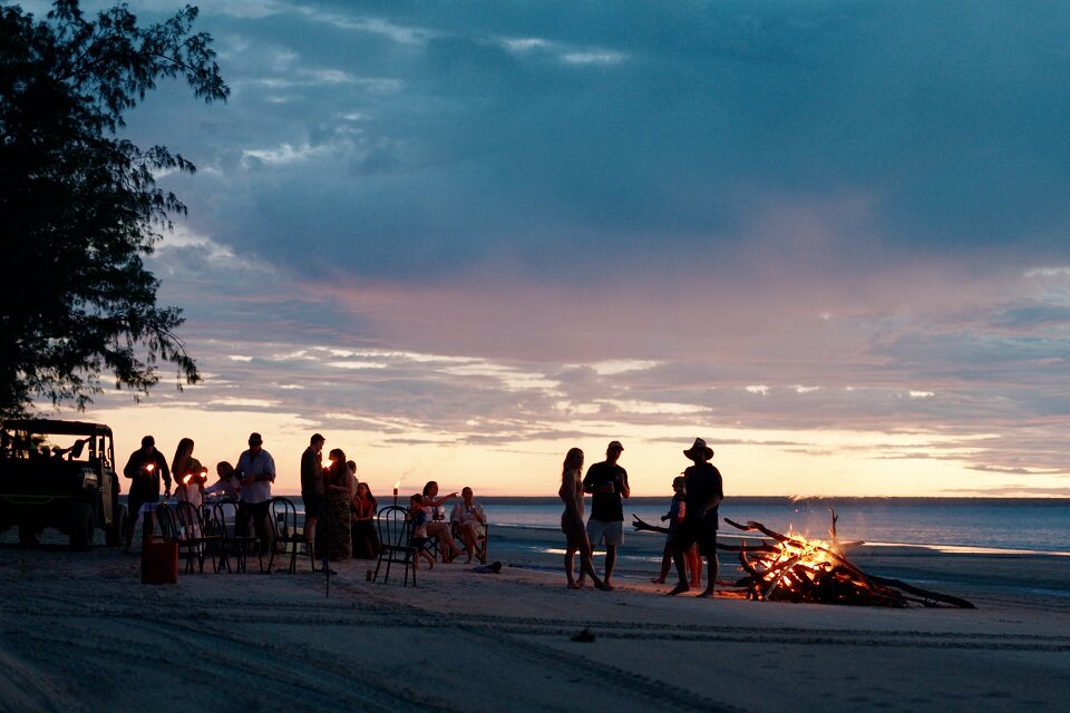 Group at a sunset bonfire