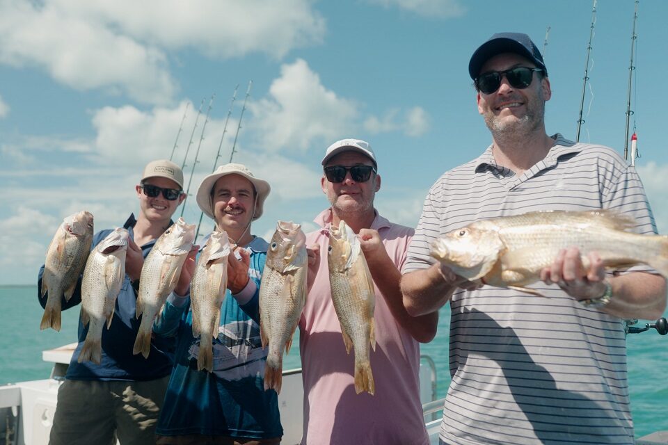 Anglers holding their fishing catches